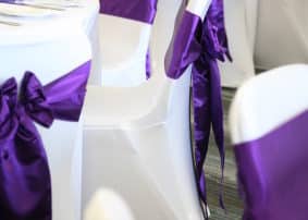 Purple Fabric on White Chairs Decoration Party Venue