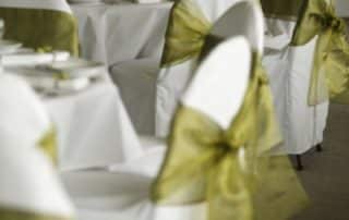 Green Bow on White Chairs