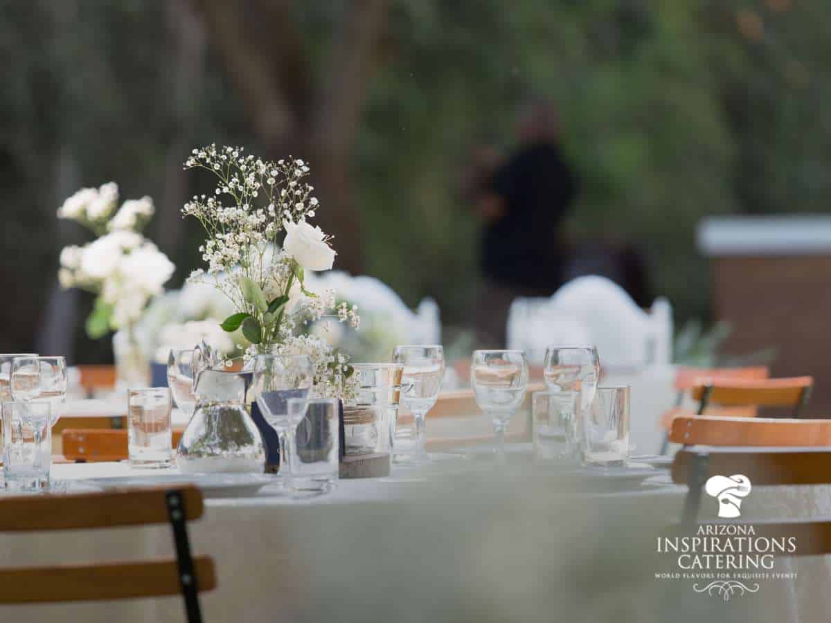 Elegant table setting with flowers at an outdoor wedding