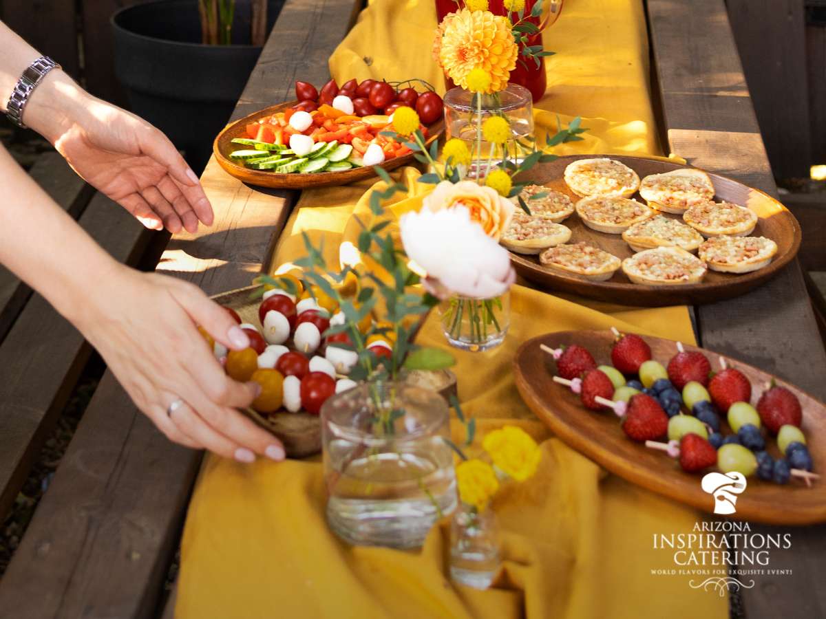 Delicious spread for engagement party catering with fresh vegetables, fruit skewers, and savory bites
